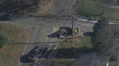 WATCH: Car stuck in 8-foot sinkhole at Bowie, Maryland intersection